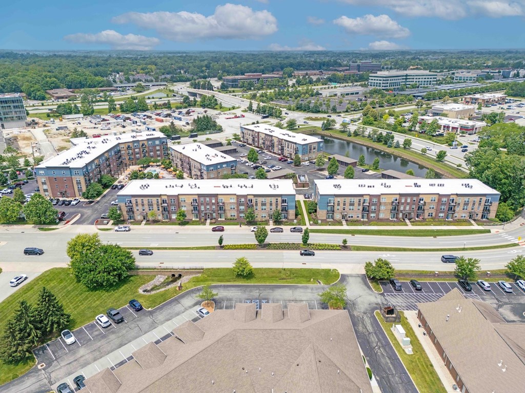 A large building complex with a parking lot in front.