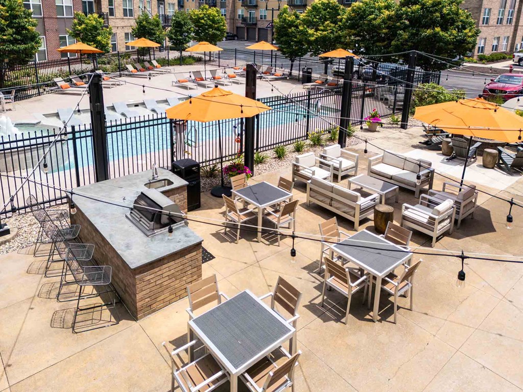 A pool area with a hot tub and lounging chairs.
