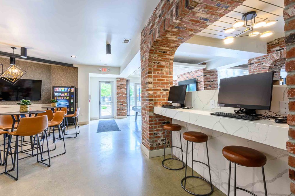 A room with a brick column and a bar area.