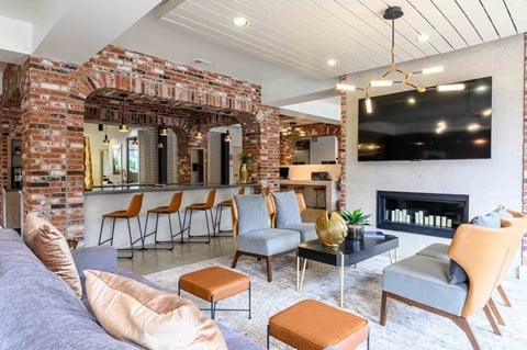 A living room with a fireplace and a large painting on the wall.