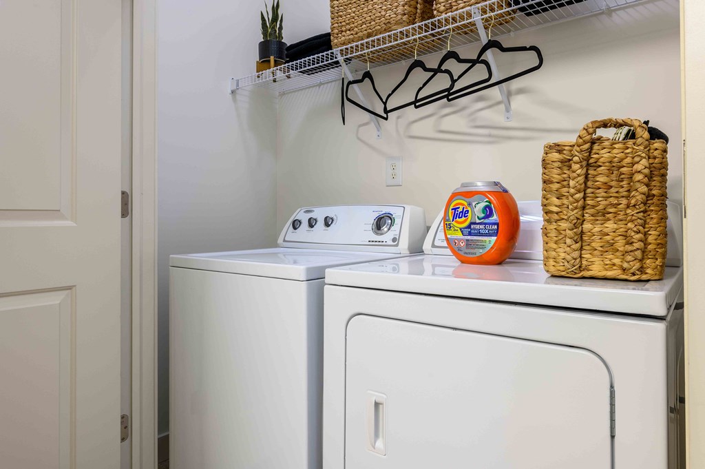 A white washing machine and dryer in a small laundry room.