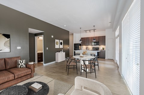 A modern living room with a brown couch and a coffee table.