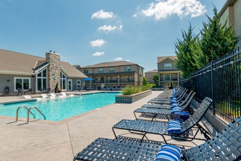 Swimming pool with sundeck and lounge seating at Prairie Pines Townhomes Apartments, Shawnee
