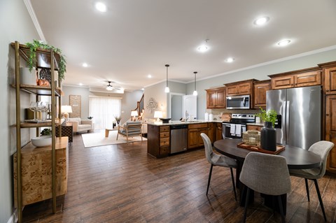 A modern kitchen with a dining table and chairs.