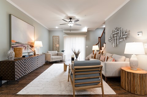 A modern living room with a wooden chair and a large painting on the wall.