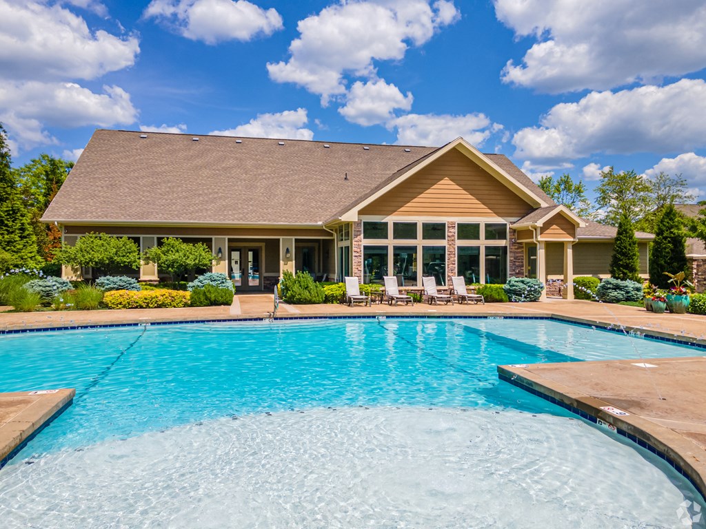 a swimming pool with a house in the background at Sovereign at Overland Park, Overland Park, KS 66213
