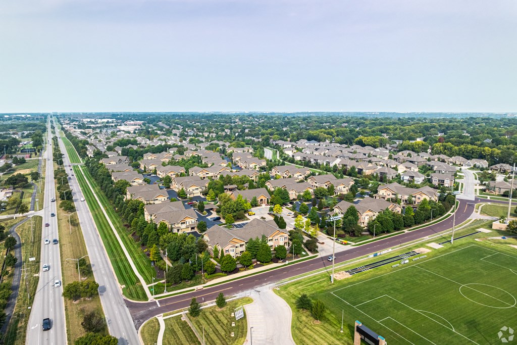 an aerial view of a neighborhood of houses and a highway at Sovereign at Overland Park, Overland Park