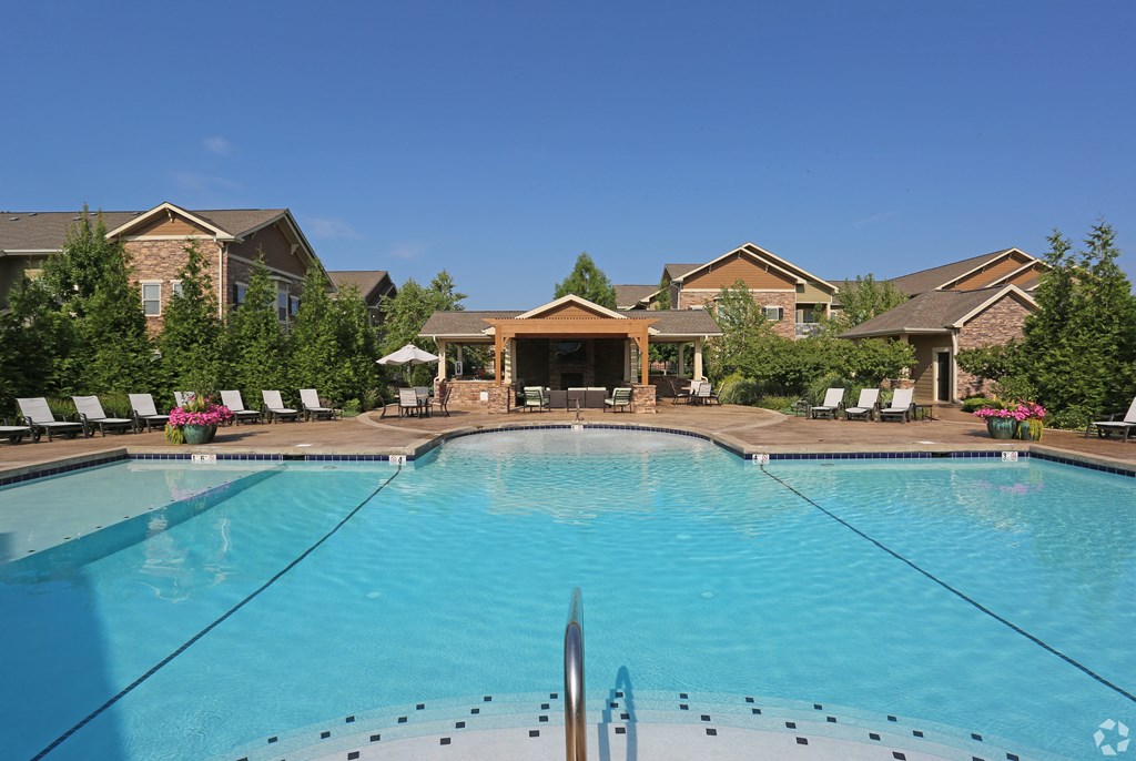 a swimming pool with apartments in the background at Sovereign at Overland Park, Overland Park, KS