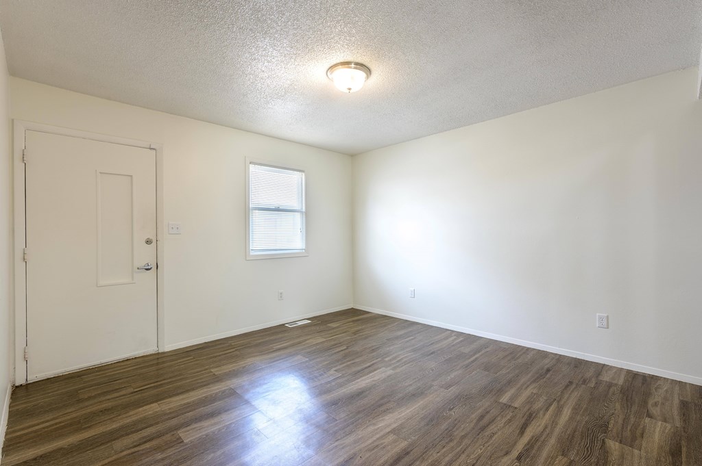 A room with wooden flooring and a window at Spring Creek Townhomes Apartments, Springfield 62702