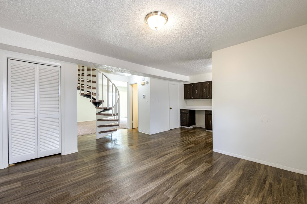 A room with wooden floors and white walls at Spring Creek Townhomes Apartments, Springfield, Illinois