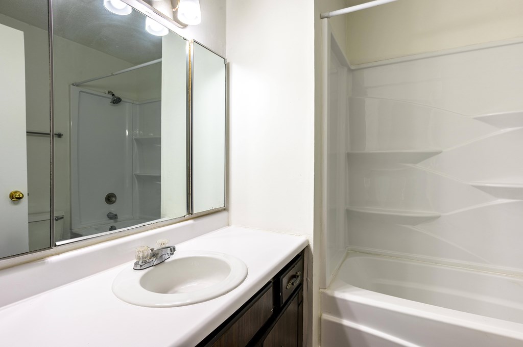A white sink with a mirror above it at Spring Creek Townhomes Apartments, Springfield 62702