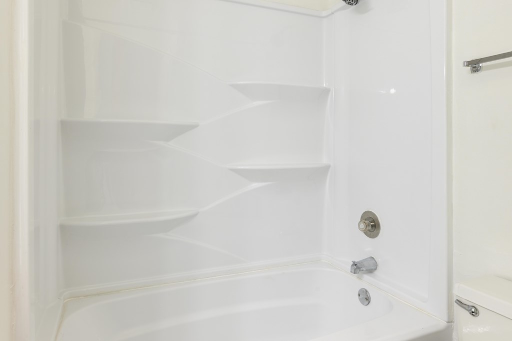 A white bathroom cabinet with shelves and a towel bar at Spring Creek Townhomes Apartments, Illinois