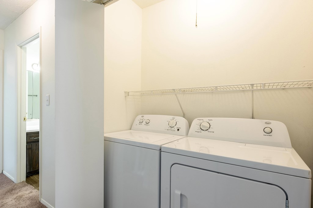 A laundry room with a washer and dryer at Spring Creek Townhomes Apartments, Illinois