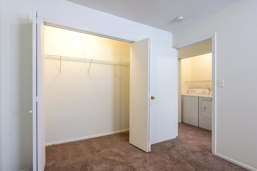 A bedroom with a white door open to a bathroom at Spring Creek Townhomes Apartments, Springfield