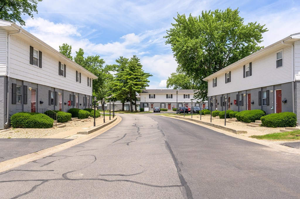 A street view of a residential area with houses on both sides at Spring Creek Townhomes Apartments, Springfield 62702