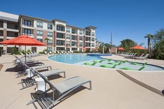 Exterior of apartments with loungers by pool