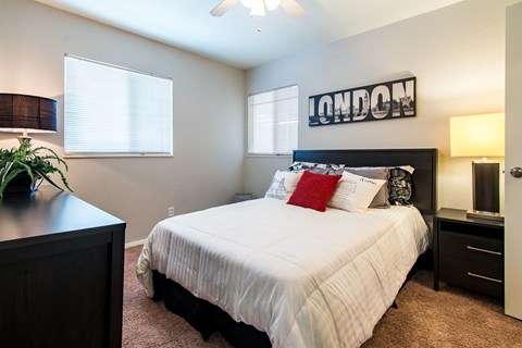 Bedroom with dark furniture and london wall art at The Boulevard Apartments, Roeland Park