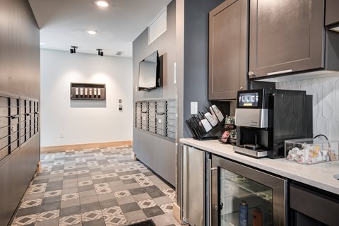 A modern kitchen with a stainless steel refrigerator and a checkered floor.