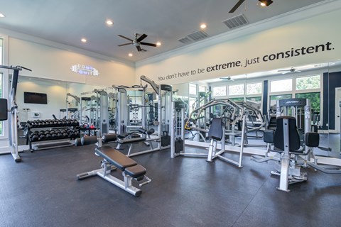 A gym with a variety of equipment and a sign that says at Sovereign at Overland Park Apartments, Overland Park, KS 66213