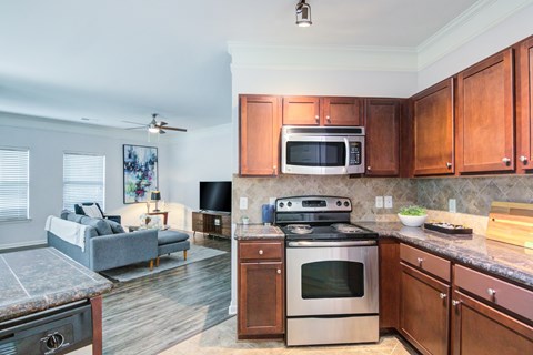 A kitchen with a stove top oven and microwave above it.