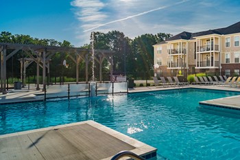 pool with apartment building in the back - Photo Gallery 3