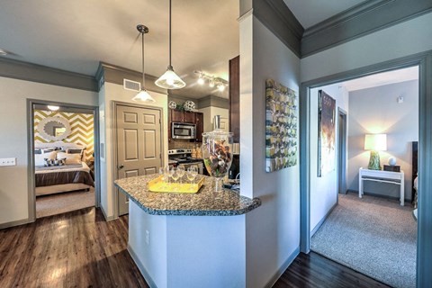 a kitchen with a granite counter top and a door to a bedroom  at Waterstone at Cinco Ranch, Katy, Texas