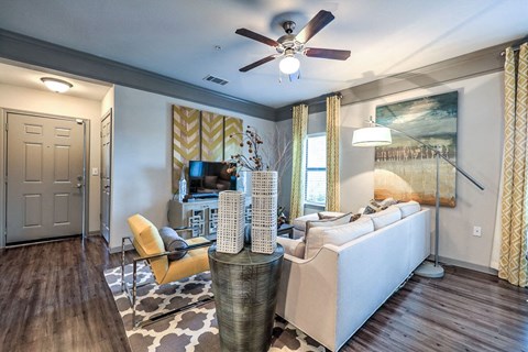 a living room with a couch and a ceiling fan at Waterstone at Cinco Ranch, Katy, TX
