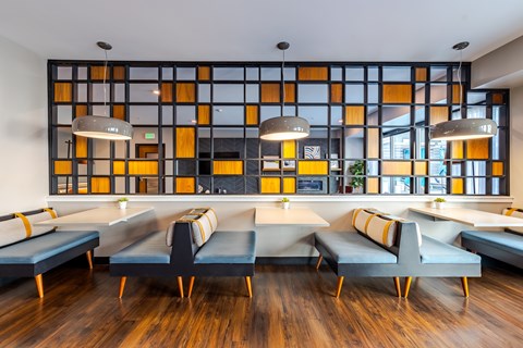 Lounge seating with backlit decorative glass partition wall at Marquee Apartments, Minneapolis, MN