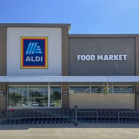 An ALDI food market storefront with shopping carts in front.