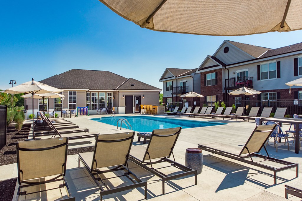 lounge chairs by pool with apartment buildings in the background at Overland Park, Ohio
