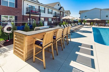 bar with chairs next to pool - Photo Gallery 7