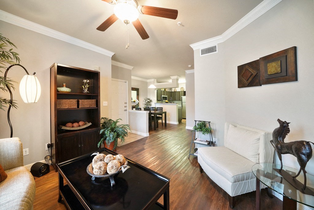 living area off kitchen with ceiling fan and wood style flooring at River Pointe, Conroe, 77304