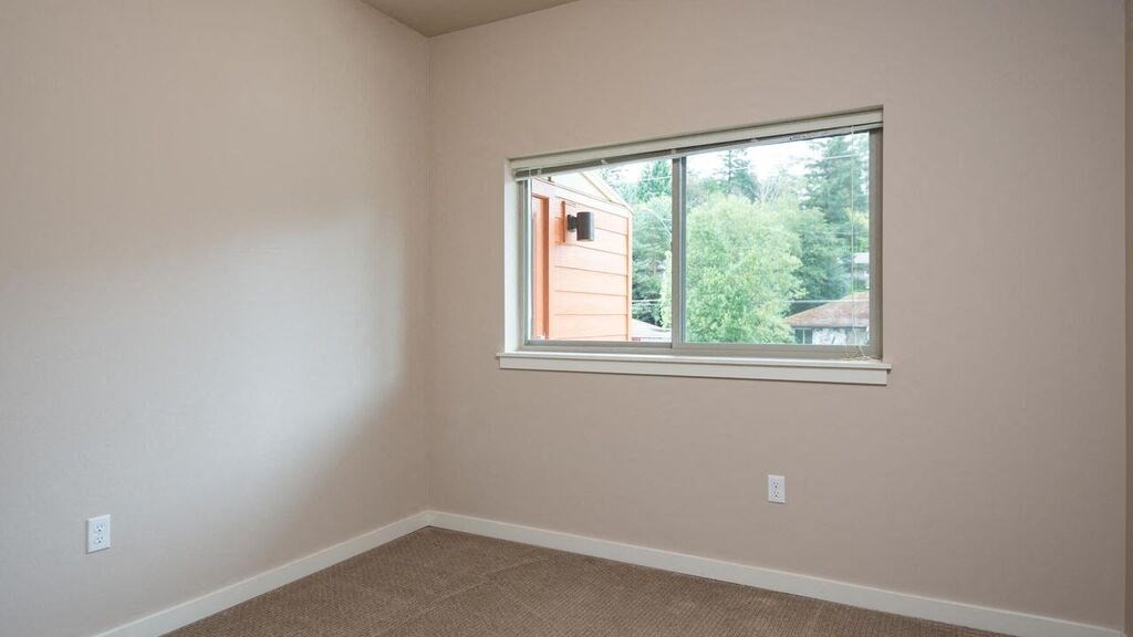 a bedroom with a large window and a