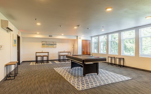 134th street lofts resident lounge and game room with a ping pong table and chairs
