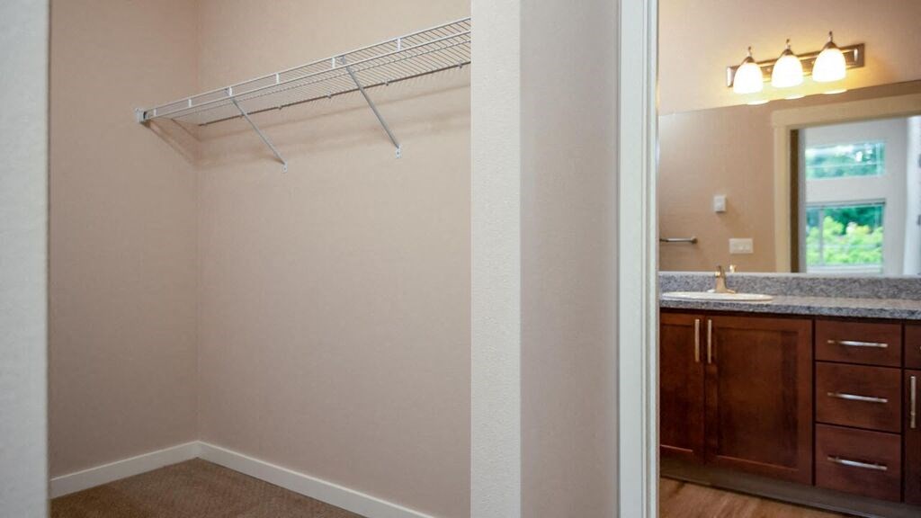 a bathroom with a shower and a sink and a mirror