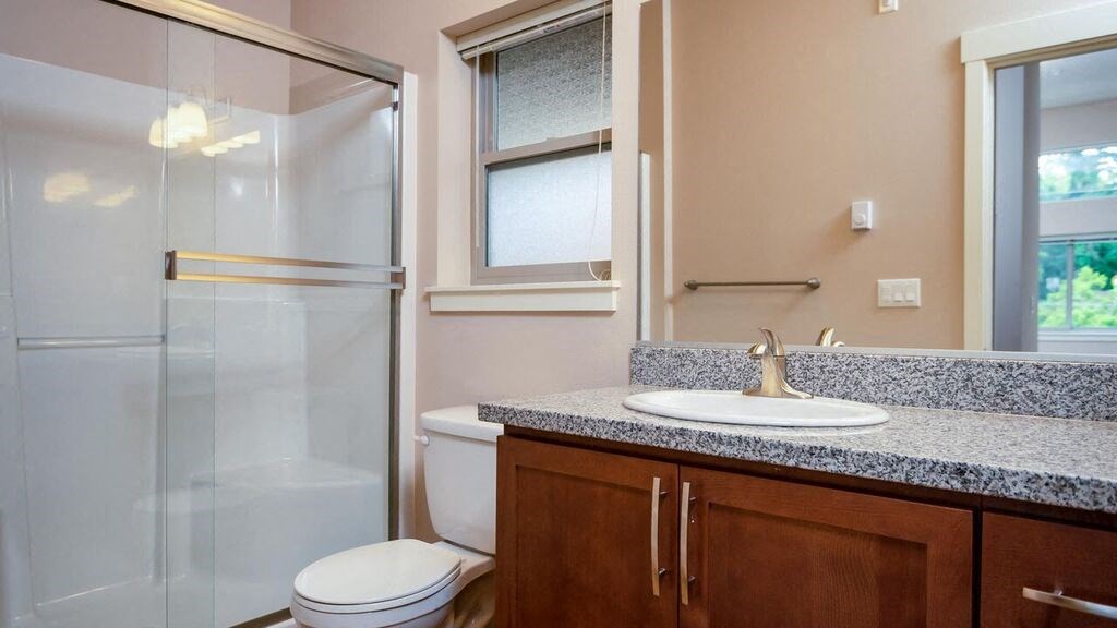 a bathroom with a sink toilet and shower