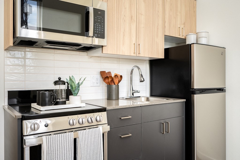 a kitchen with stainless steel appliances and wooden cabinets