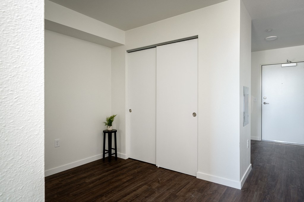 an empty room with white walls and a closet