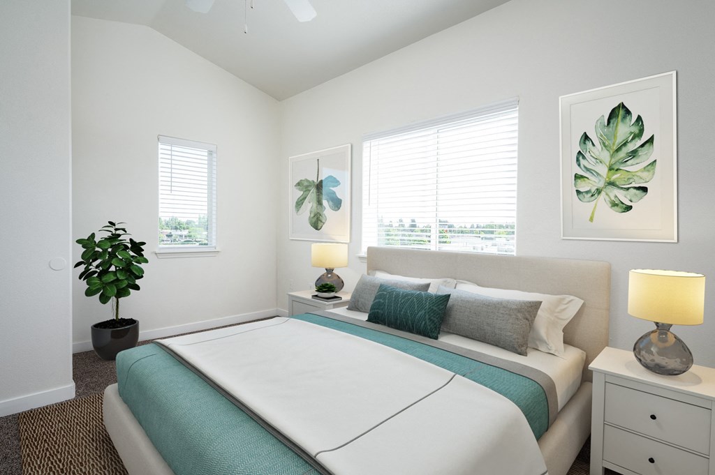 a bedroom with a bed and two windows