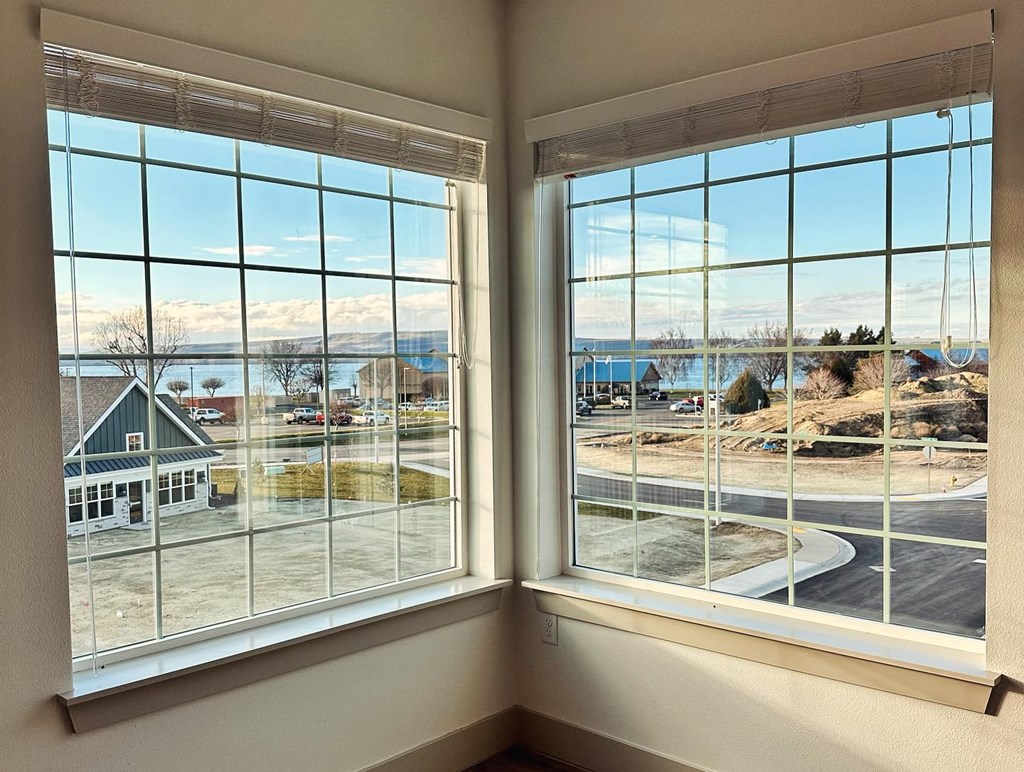a corner window with a view of a building and a street