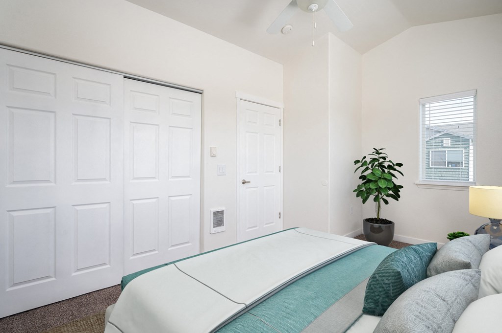 a bedroom with a bed and a ceiling fan