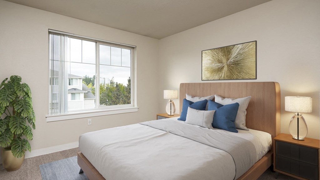 a bedroom with a large window and a large potted plant