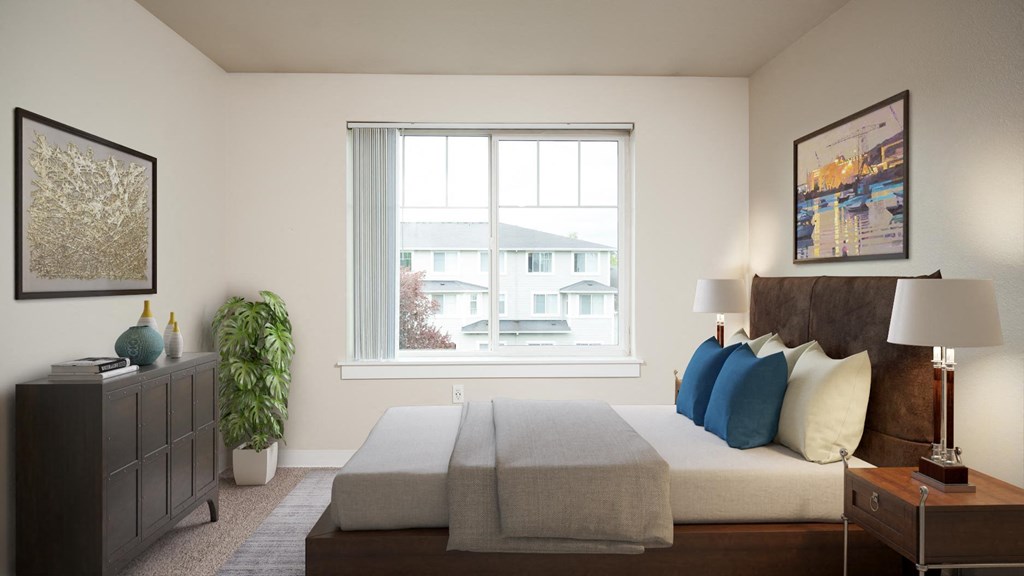 a bedroom with a large window and a bed with blue and white pillows