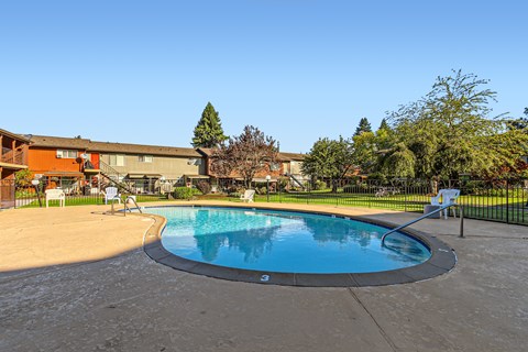 A small round pool with a concrete floor and a concrete wall around it.