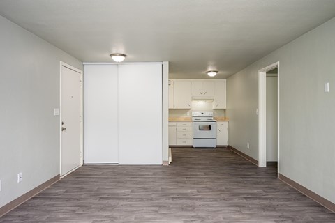 A kitchen with white cabinets and appliances is shown.