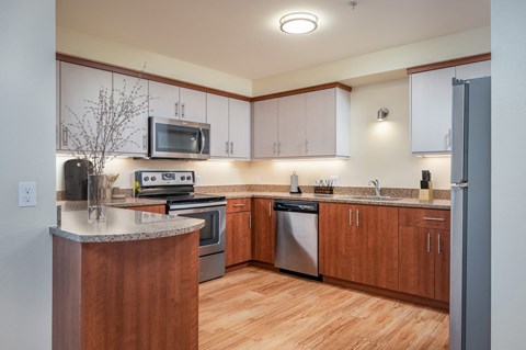 a kitchen with wooden cabinets and stainless steel appliances