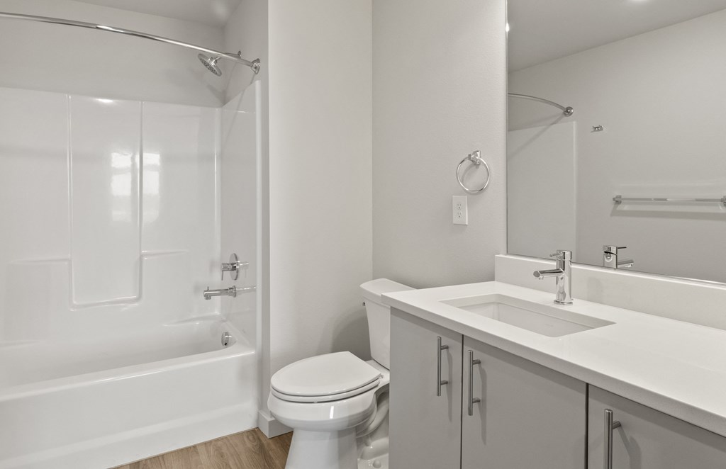 an empty bathroom with a sink toilet and shower