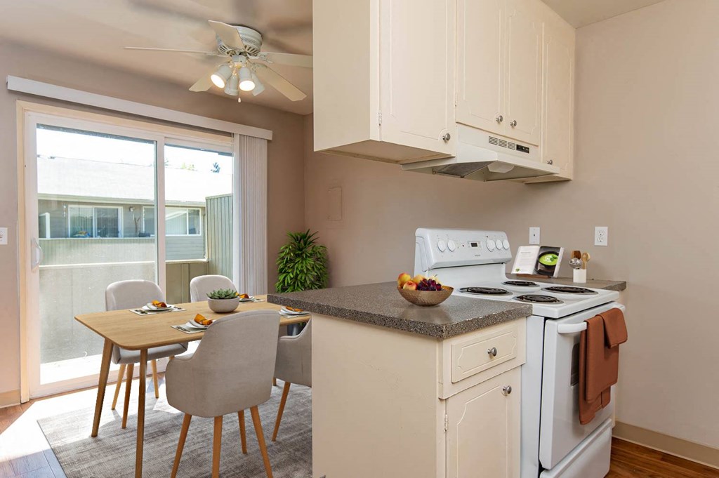 a kitchen with a table and chairs and a stove