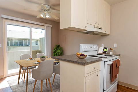 a kitchen with a table and chairs and a stove