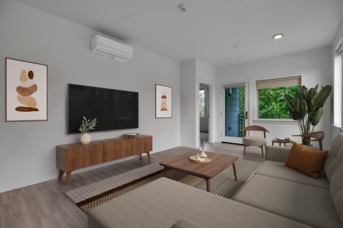 A living room with a grey couch and a wooden coffee table.